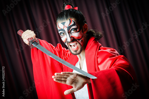 Photo: Man with sword and face mask Man with sword and face mask