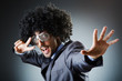 Man with afro haircut singing in studio