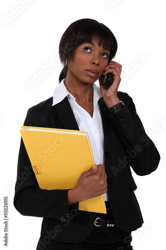 Photo: Afro-American businesswoman talking on her cell Afro-American businesswoman talking on her cell