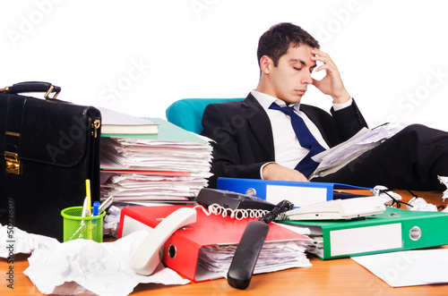 Photo: Young busy businessman at his desk Young busy businessman at his desk