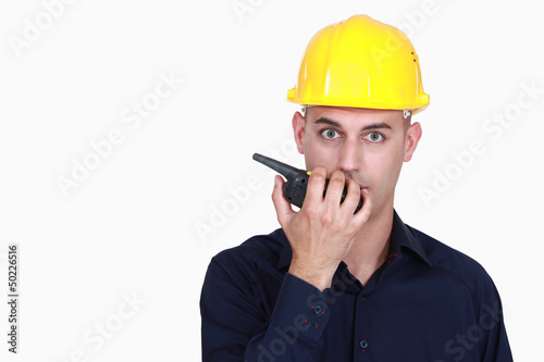 Photo: A foreman talking over the phone. A foreman talking over the phone.