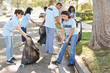 Team Of Volunteers Picking Up Litter In Suburban Street