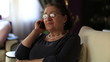 elderly woman talking on the mobile phone at home
