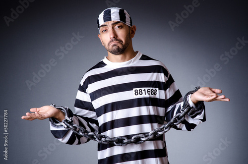 Photo: Convict criminal in striped uniform Convict criminal in striped uniform