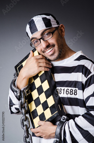 Photo: Convict criminal in striped uniform Convict criminal in striped uniform