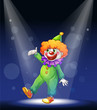 A clown at the center of the stage with a spotlight