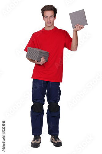 Photo: Tradesman holding a stack of tiles Tradesman holding a stack of tiles