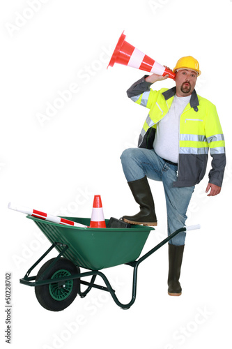 Photo: Worker listening through a traffic cone Worker listening through a traffic cone