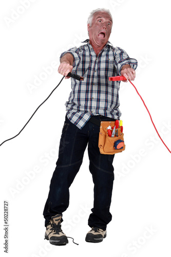 Photo: Man getting an electric shock from jump leads Man getting an electric shock from jump leads