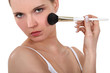 Woman applying blusher