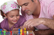 Father and daughter playing board game