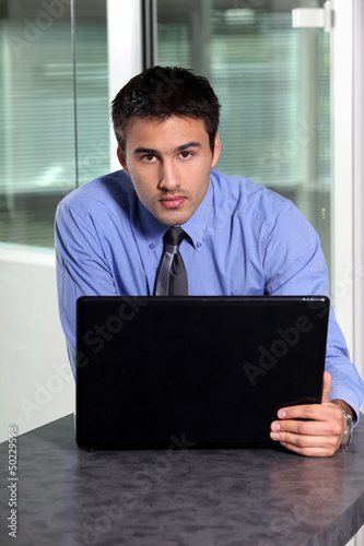 Photo: Young businessman using laptop computer Young businessman using laptop computer