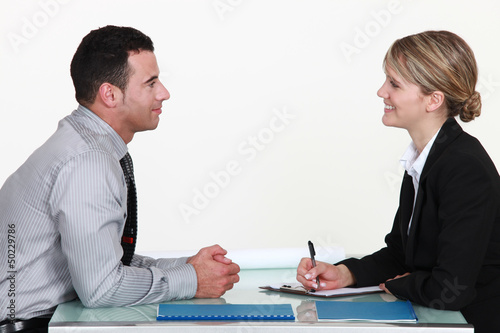 Photo: A man and a woman during an interview. A man and a woman during an interview.