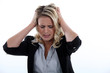 young blonde having migraine