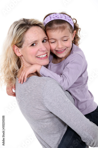 Photo: Woman hugging little girl Woman hugging little girl