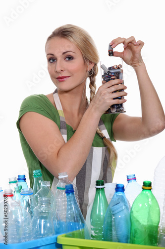 Photo: Woman recycling batteries and plastic bottles Woman recycling batteries and plastic bottles