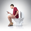 Man with mobile phone sitting on the toilet