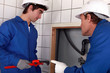 Plumber and his apprentice working together