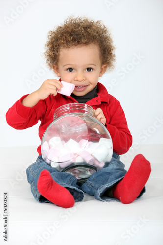Photo: Toddler eating marshmallows Toddler eating marshmallows