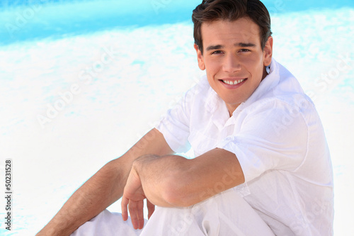 Photo: young guy sitting outside young guy sitting outside