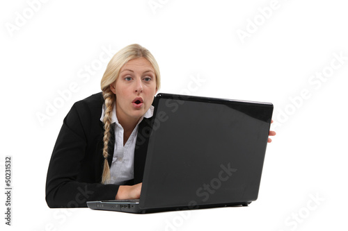 Photo: Woman surprised in front of a computer Woman surprised in front of a computer