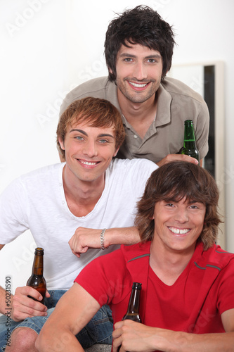Photo: Three lads with bottles of beer Three lads with bottles of beer