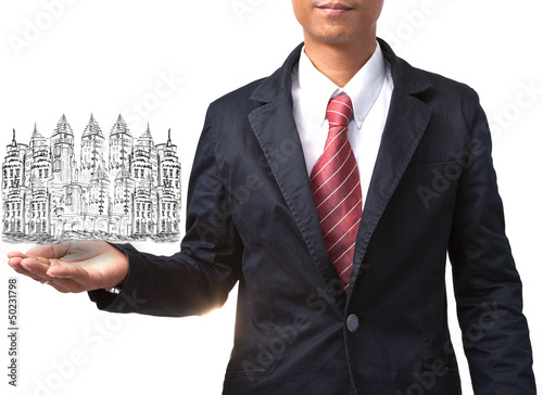 Photo: business man holding drawing of modern building business man holding drawing of modern building
