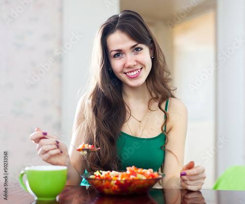 Photo: Woman eats veggie salad Woman eats veggie salad