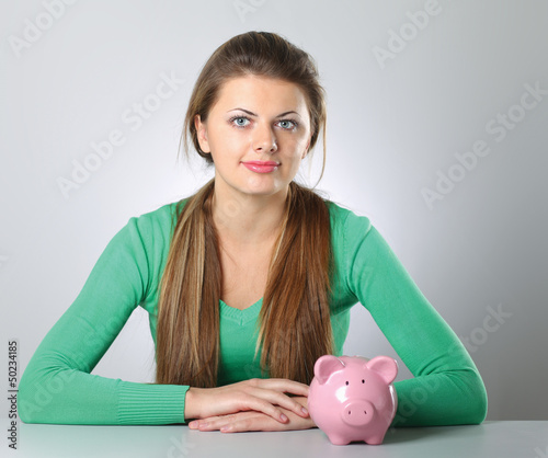 Photo: Young beautiful woman with piggy bank Young beautiful woman with piggy bank