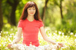 Pretty woman meditate in the park