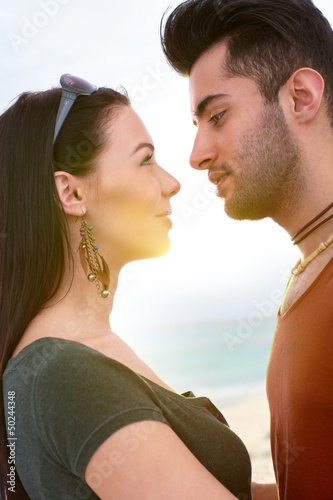 Photo: Young couple kissing on the beach Young couple kissing on the beach