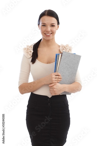 Photo: Smiling young secretary with files Smiling young secretary with files