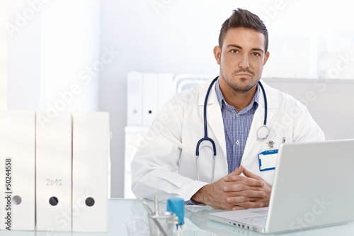 Photo: Young doctor working in office Young doctor working in office