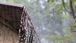 Strong rain flows on a roof and flows down on earth