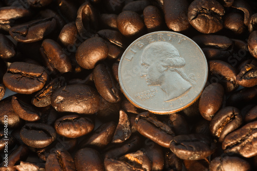 Photo: Coffee beans and quarter coin Coffee beans and quarter coin