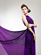 Beautiful fashion woman in violet long dress