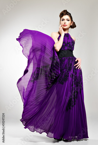 Photo: Beautiful fashion woman in violet long dress Beautiful fashion woman in violet long dress