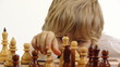 little boy playing chess
