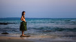 Indigene woman in the palm skirt, seashells necklace and coconut