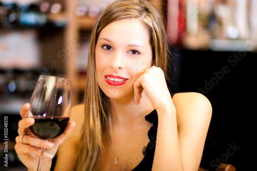 Photo: Beautiful woman holding a glass of wine Beautiful woman holding a glass of wine