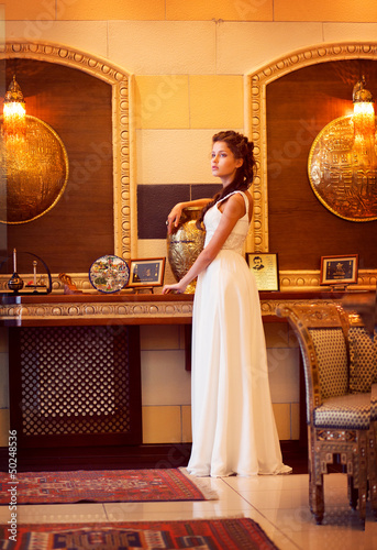 Photo: Aristocracy. Rich Lady standing. Orient Antique Interior Aristocracy. Rich Lady standing. Orient Antique Interior