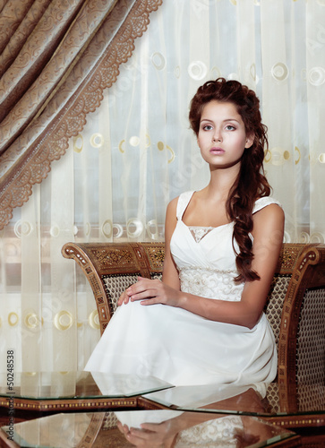 Photo: Femininity. Bride in Wedding Dress. Classic Romantic Interior Femininity. Bride in Wedding Dress. Classic Romantic Interior