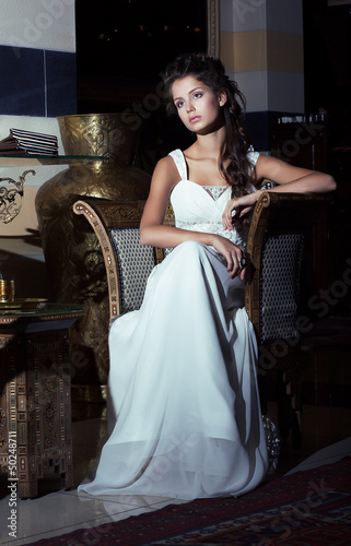 Photo: Wedding Style. Bride sitting in White Dress. Restaurant Interior Wedding Style. Bride sitting in White Dress. Restaurant Interior