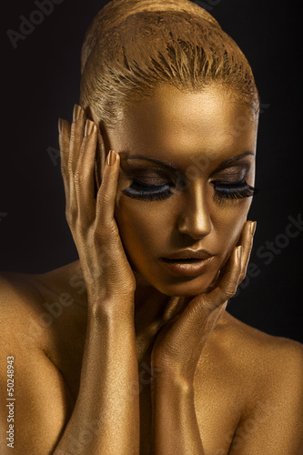 Photo: Face Art. Fantastic Gold Make Up. Stylized Colored Woman's Body Face Art. Fantastic Gold Make Up. Stylized Colored Woman's Body