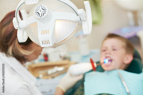 Photo: dental filing of child tooth by ultraviolet light dental filing of child tooth by ultraviolet light