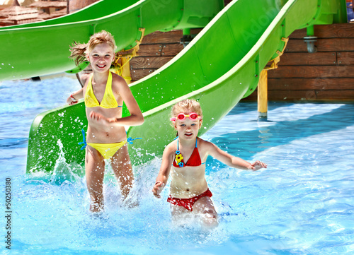 Photo: Child on water slide at aquapark. Child on water slide at aquapark.