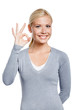 Half-length portrait of female okay gesturing, isolated on white