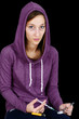 Young woman with syringe and drugs over black