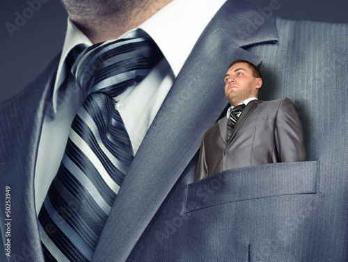 Photo: Small businessman in suit pocket Small businessman in suit pocket