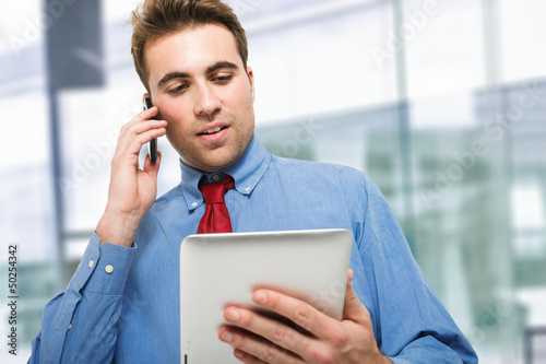 Photo: Young businessman talking on the phone Young businessman talking on the phone